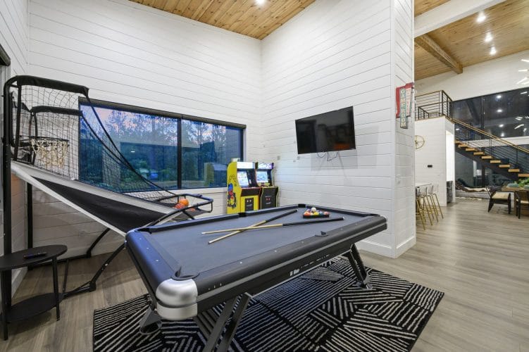 Game room with a pool table, a Pop-A-Shot basketball game, an arcade cabinet and a wall TV