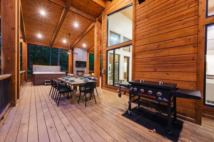 Covered deck with an outdoor dining table and a Blackstone griddle