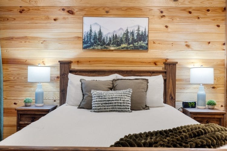 Bed with white bedding and a mountain print above