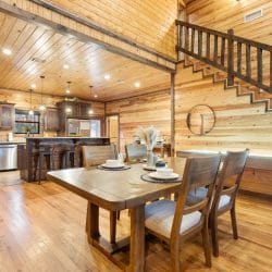 Dining table by the kitchen with the staircase behind