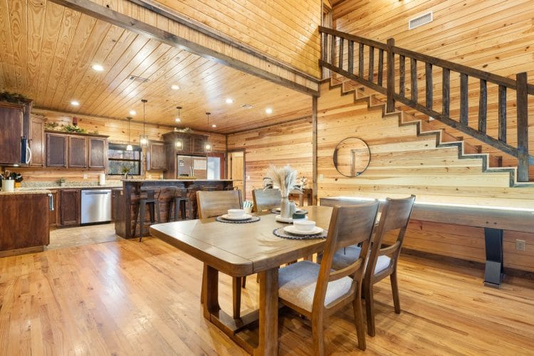 Dining table by the kitchen with the staircase behind