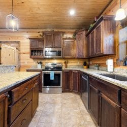 Kitchen with granite counters, a stainless range and a tile floor