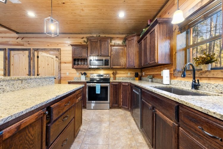 Kitchen with granite counters, a stainless range and a tile floor