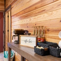 Coffee bar with mugs, syrups and a drip machine by the back door