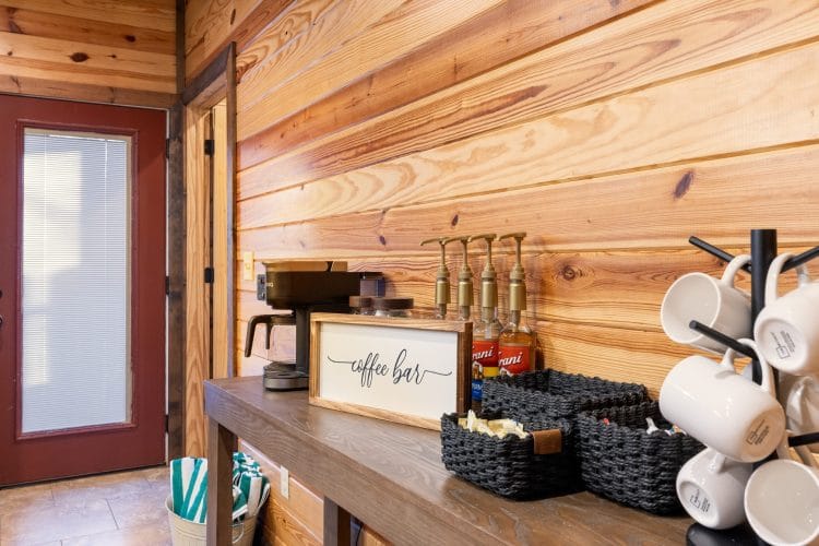 Coffee bar with mugs, syrups and a drip machine by the back door