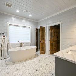 Freestanding tub, white bathrobes and a double vanity