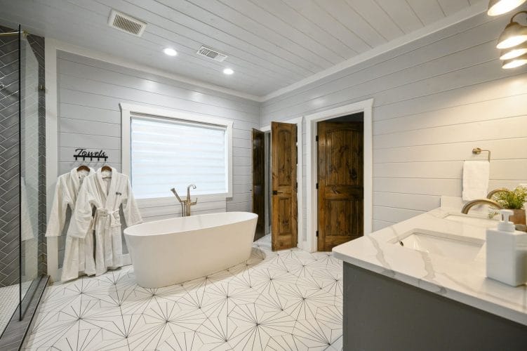 Freestanding tub, white bathrobes and a double vanity