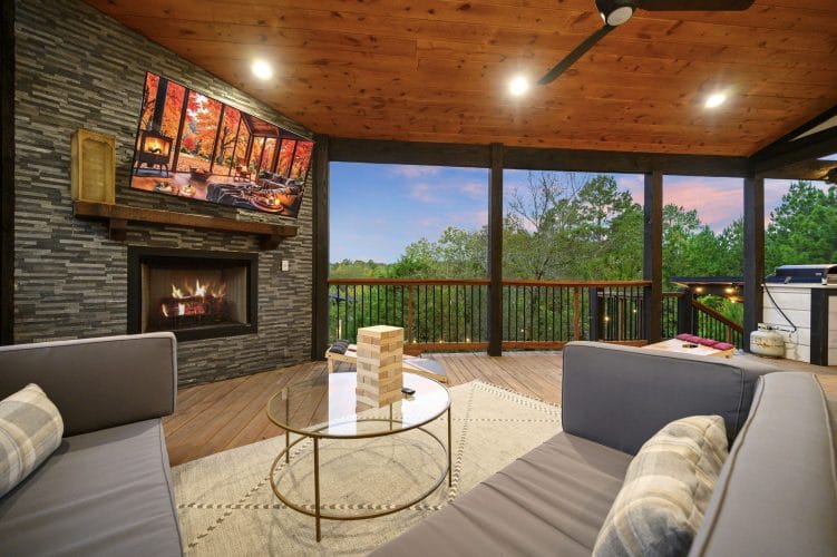 Gas fireplace with a TV above it and a glass coffee table with Jenga blocks