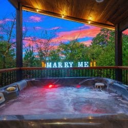 Hot tub with red lights under the covered platform and a lit marquee sign