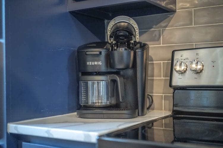 Keurig coffee maker on the counter beside the stove