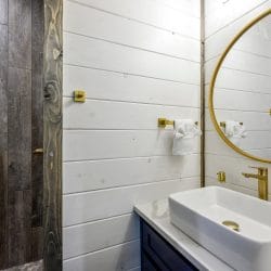 Gold towel hook on white shiplap