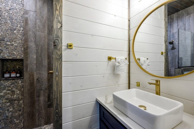 Gold towel hook on white shiplap