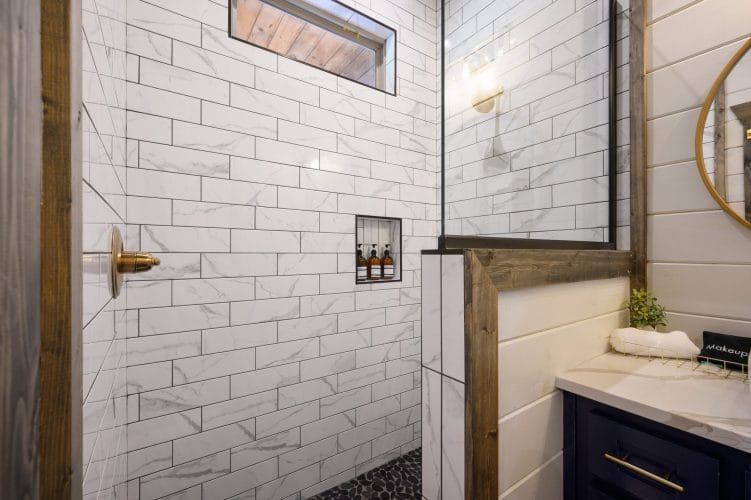 Shower niche with three amber bottles in white marble-look tile