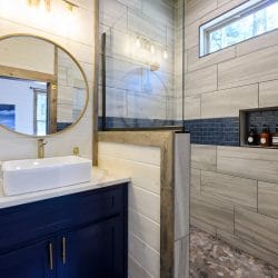 Blue tile above a rustic wood-framed edge in a bathroom