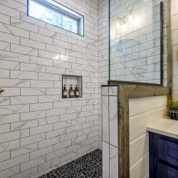 Shower niche with bottles in white marble-look tile