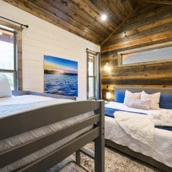 Lake photo print on the wall beside a bedroom window