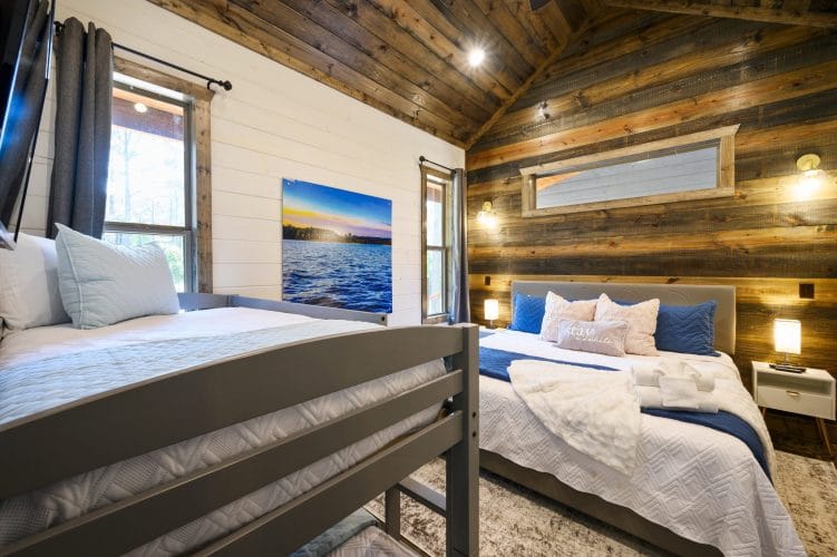 Lake photo print on the wall beside a bedroom window