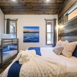 Framed print of blue lake water on a white shiplap wall