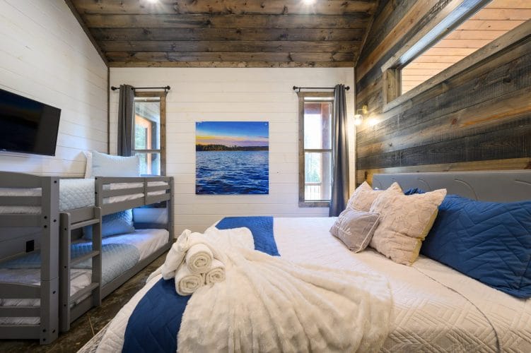 Framed print of blue lake water on a white shiplap wall