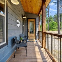 Wood-and-glass entry door beside gray siding