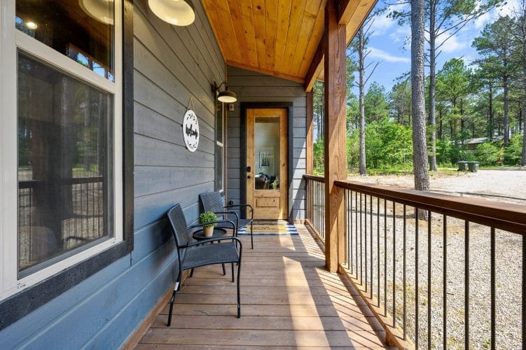 Wood-and-glass entry door beside gray siding