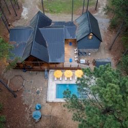 Aerial view of the deck, three yellow umbrellas by the pool and the metal roof