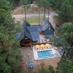 Aerial view of the cabin roofline, back deck and pool umbrellas