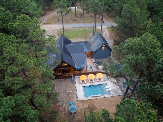 Aerial view of the cabin roofline, back deck and pool umbrellas