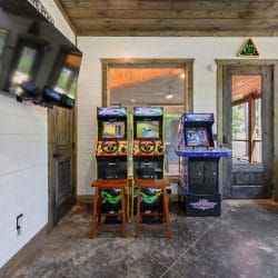 Two racing arcade machines with steering wheels