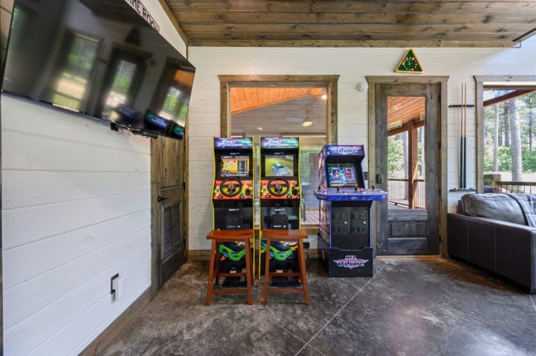 Two racing arcade machines with steering wheels