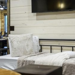 Close view of a fluffy pillow against a black metal daybed frame