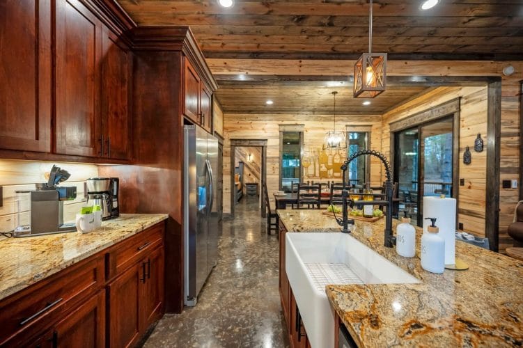 Dining table seen from the refrigerator with a gold wine-bottle art piece on the wall