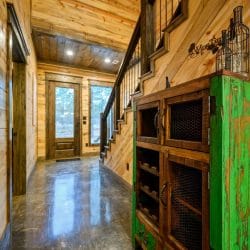 Staircase and a built-in wood cabinet with wire-mesh doors