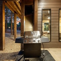 Stainless gas grill on the covered patio