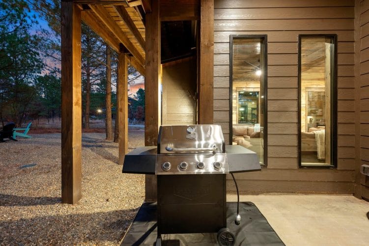 Stainless gas grill on the covered patio