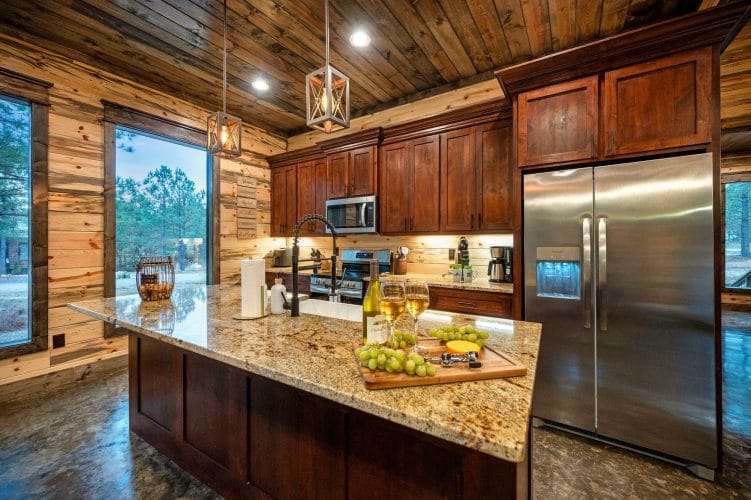 Kitchen counter with a pull-down faucet and two glasses of white wine