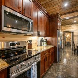 Under-cabinet lights over a granite counter with a coffee maker