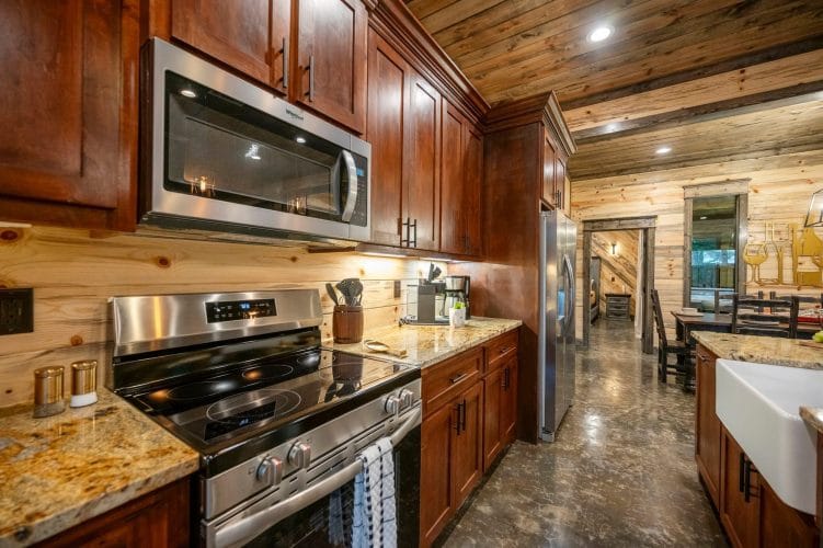 Under-cabinet lights over a granite counter with a coffee maker