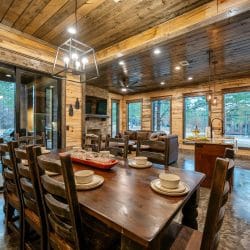 View from the dining table across the living room to the fireplace and leather couches