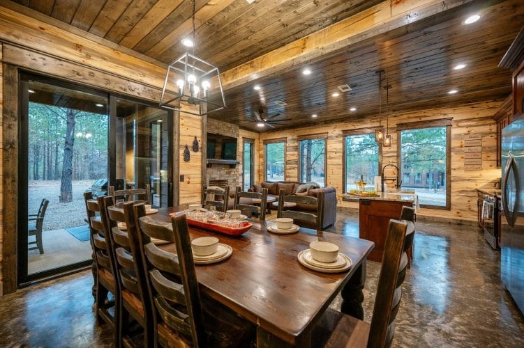 View from the dining table across the living room to the fireplace and leather couches