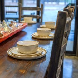Close view of stoneware plates and bowls on a table