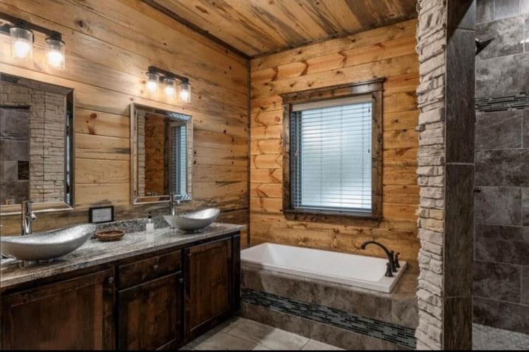 Soaking tub under a window beside a vessel-sink vanity