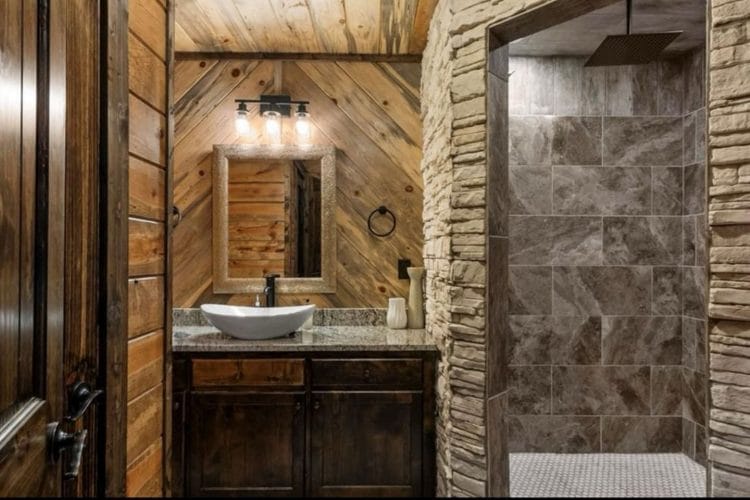 Vanity with a vessel sink beside a tiled walk-in shower