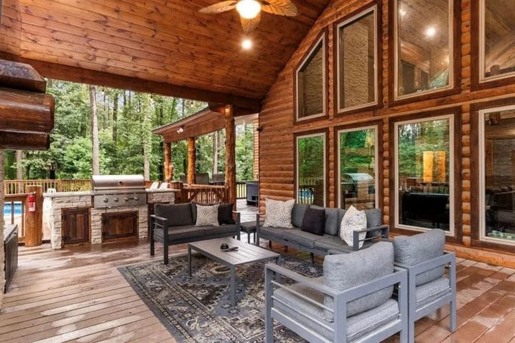 Covered deck seating and the built-in grill area under a vaulted ceiling