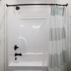 White tub-and-shower with a blue striped curtain