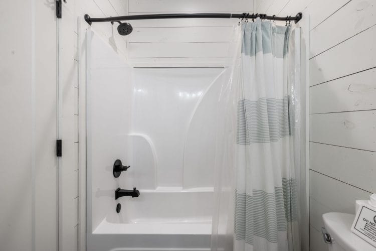 White tub-and-shower with a blue striped curtain