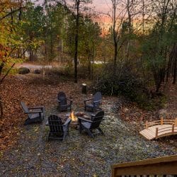Fire pit with five Adirondack chairs, the footbridge and fall leaves