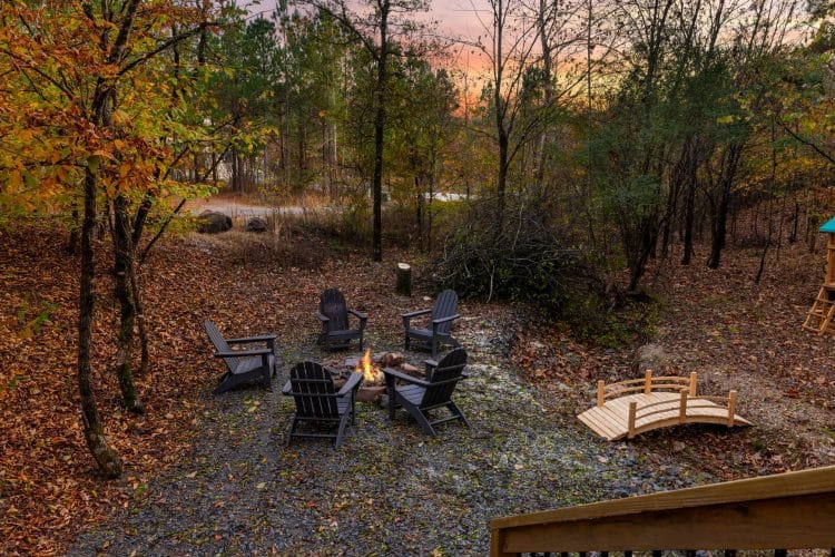 Fire pit with five Adirondack chairs, the footbridge and fall leaves
