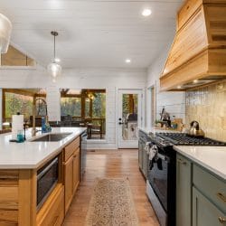 Island with a sink and built-in microwave drawer, and the gas range at right