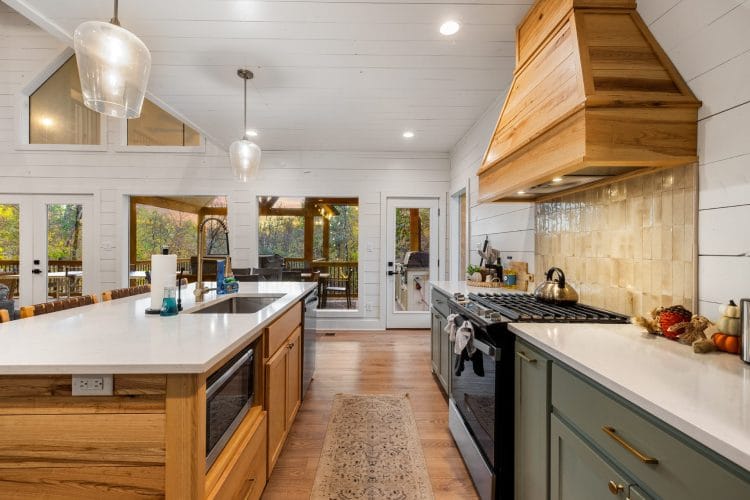 Island with a sink and built-in microwave drawer, and the gas range at right